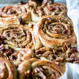 A close up of apple pecan pinwheels in a baking pan