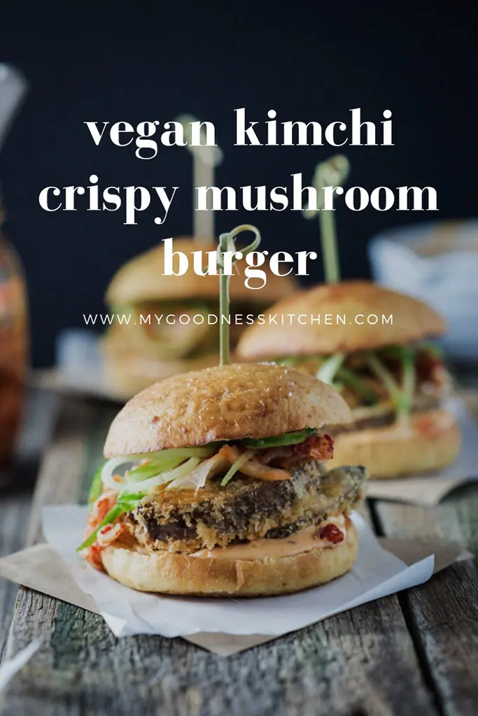 Three vegan kimchi crispy mushroom burgers with one close-up on a rustic wooden table. with title text overlay.