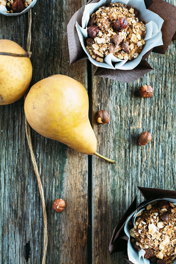 Vegan hazelnut pear and chocolate muffins are sweetened with pears, lavished with dark chocolate buttons & topped with toasted hazelnut chocolate streusel.