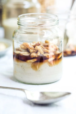 A jar of banana panna cotta with nuts