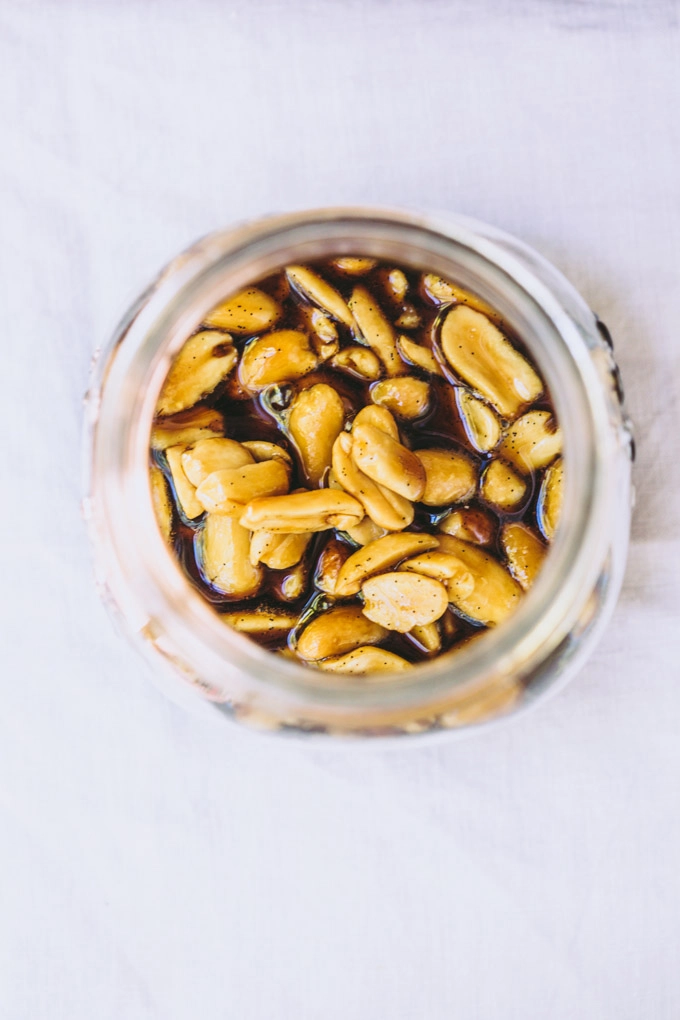 overhead image of the sticky caramel with peanuts as it sets on the vegan pan cotta