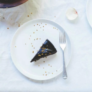 A piece of raw chocolate cake on a white plate