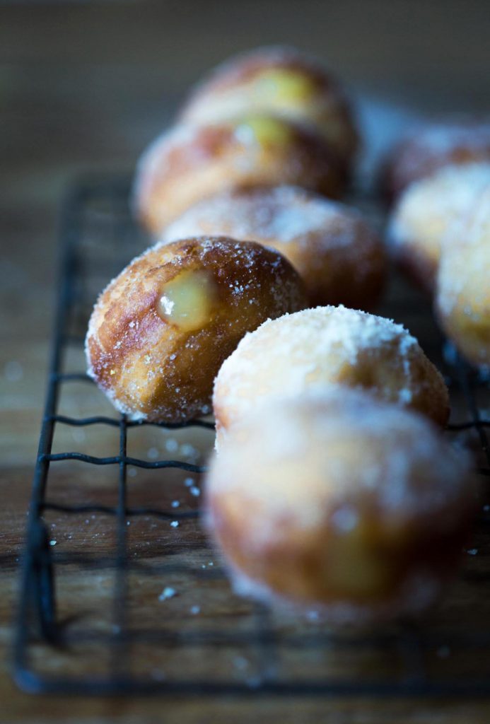 A close up of a tray of homemade donuts