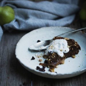 A flourless pear and chocolate cake on a plate