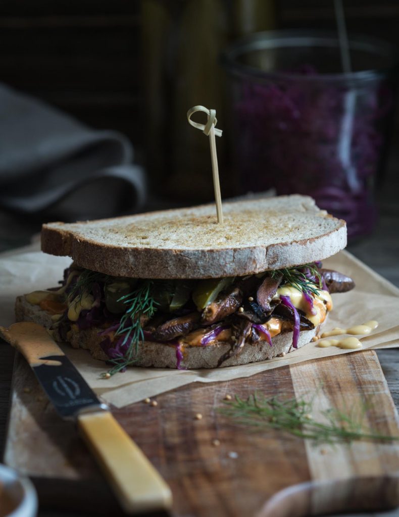 Vegan Mushroom Reuben Sandwich sitting on a cutting board