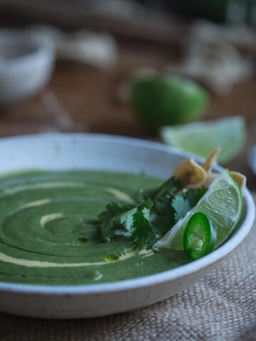A bowl of broccoli and jalapeño soup in a white bowl.