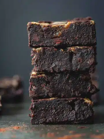 Black bean brownie squares stacked on top of each other.
