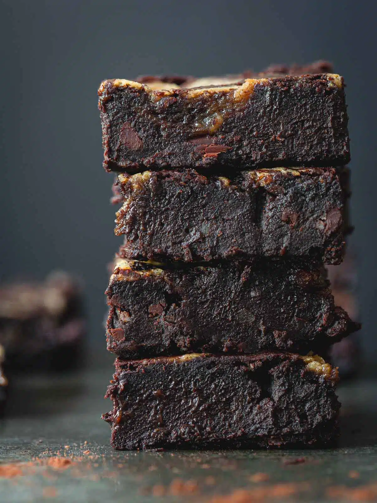 Black bean brownie squares stacked on top of each other.