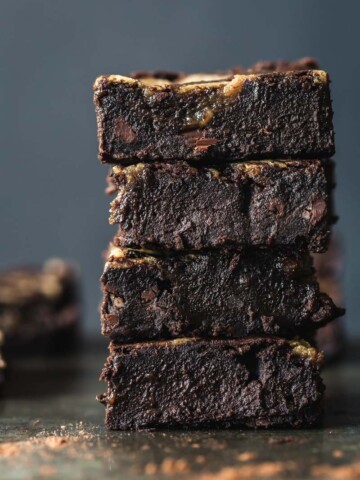 A front on image of a stack of black bean brownies with tahini caramel.