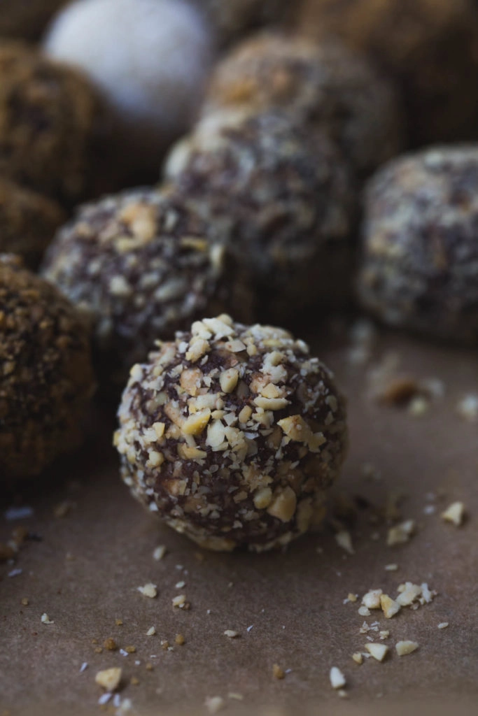 close up image of salted peanut chocolate vegan truffles on a tray