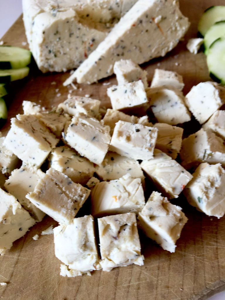 Chunks of vegan feta on a wooden board