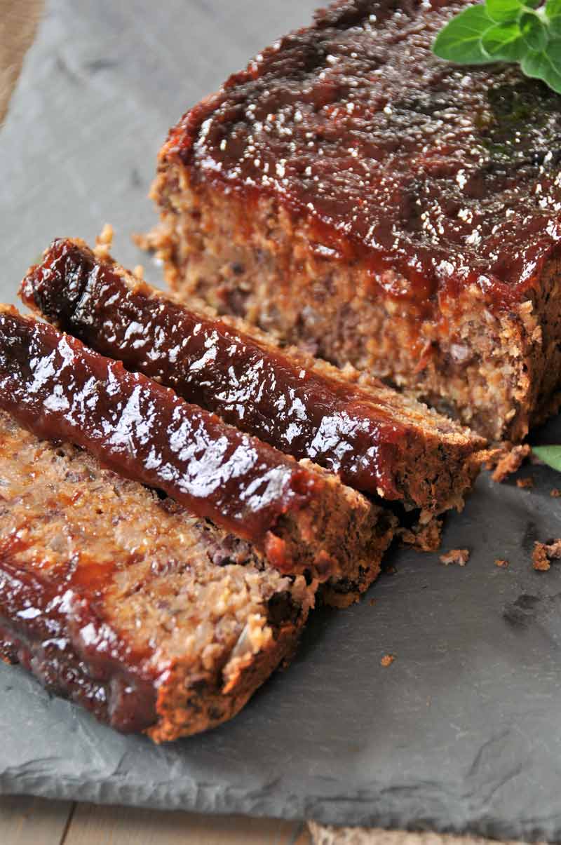 A close up image of smoky-style meatless meatloaf cut in to slices