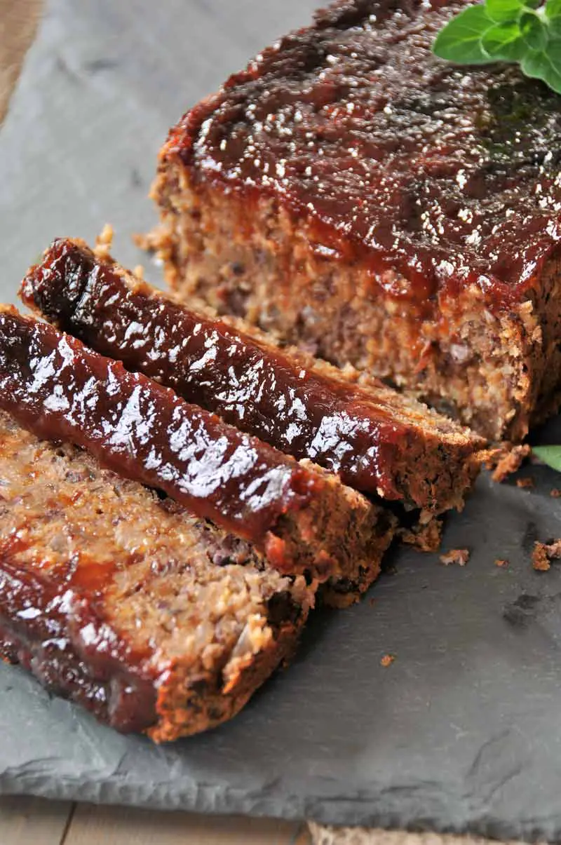 A close up image of smoky-style meatless meatloaf cut in to slices