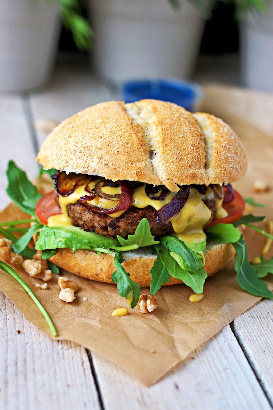 A vegan lentil burger with sauce sitting on a white board