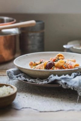 A bowl of vegan creamy pasta in a bowl on a bench