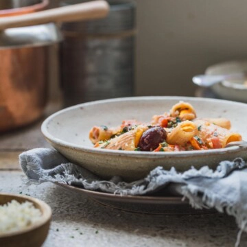 A bowl of vegan creamy pasta in a bowl on a bench