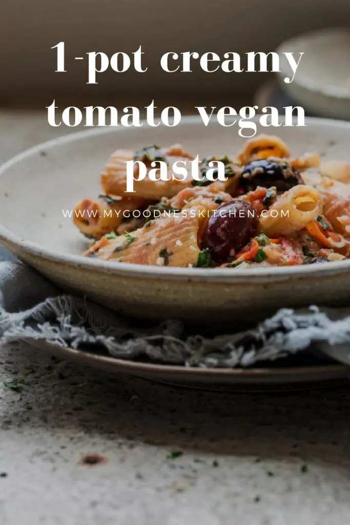 a close up image of 1-pot creamy tomato vegan pasta with text