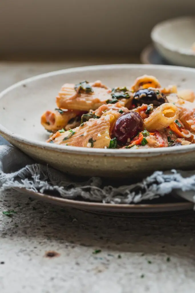 A close up image of a bowl of 1-pot creamy tomato vegan pasta