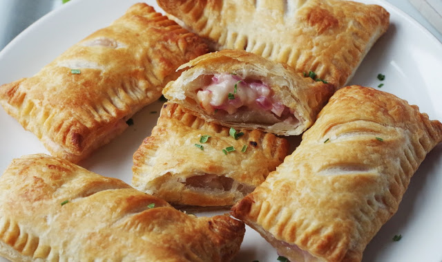 Stuffed pastry parcels on a white plate. 