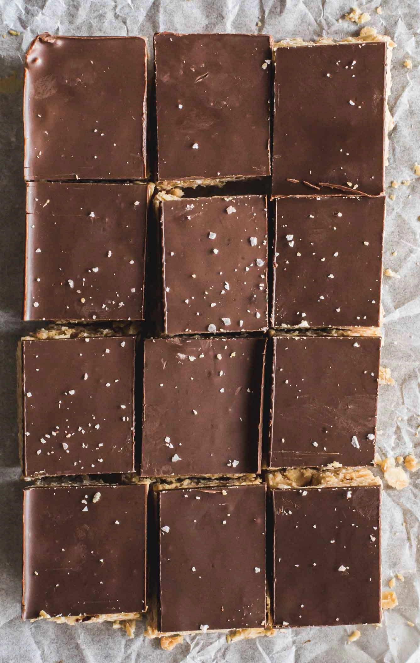 flat lay image of no-cook no-cook peanut chocolate oat squares on baking paper