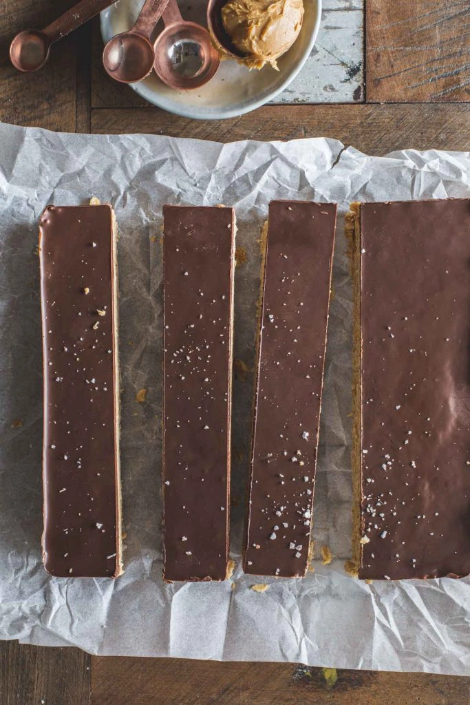 flat-lay image of no-cook peanut butter and chocolate oat squares cut in to bars