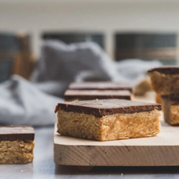 Peanut butter oatmeal squares with chocolate on a  wooden board