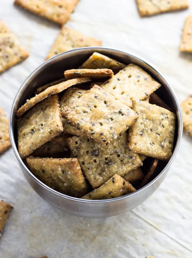 Square homemade crackers in a bowl.