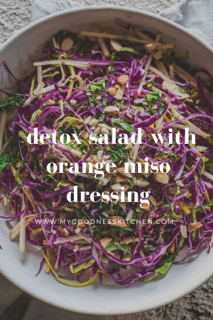 close-up flat-lay image of a large bowl of detox salad with orange miso dressing with title text overlay