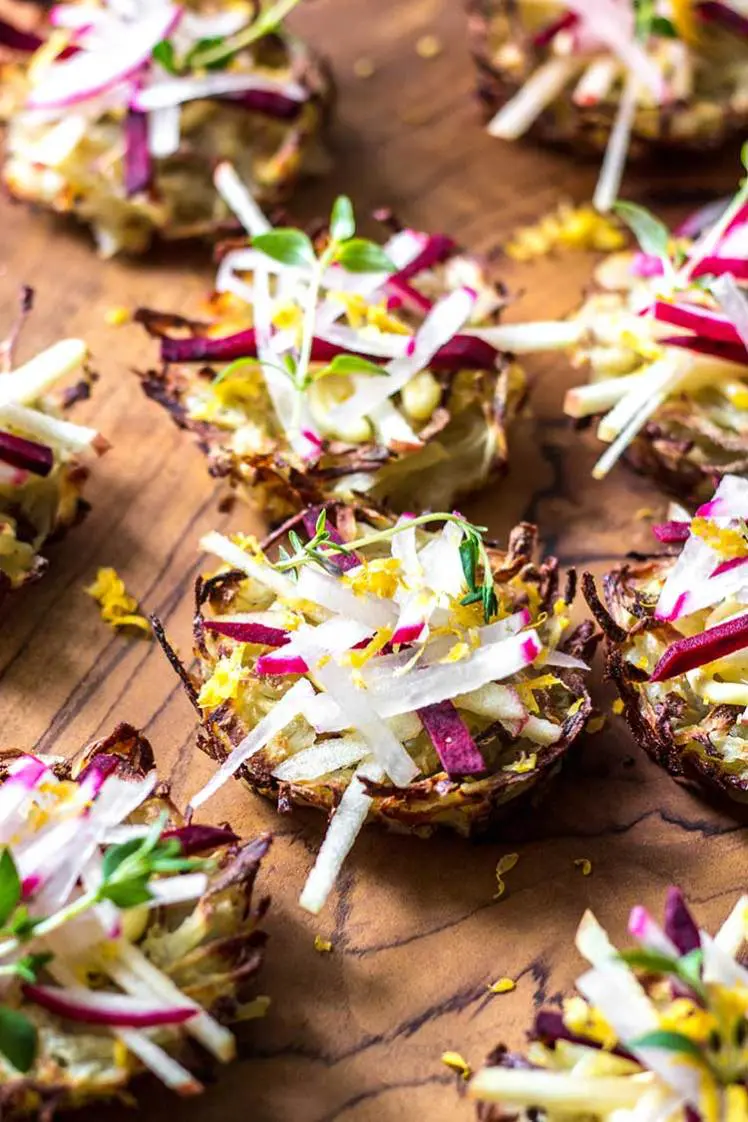 35 Vegan Party Food Recipes. No.1 Potato Nests from Quite Good Food sitting on a wooden chopping board. 