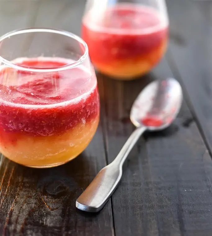 A red and orange frozen cocktail in glasses. 