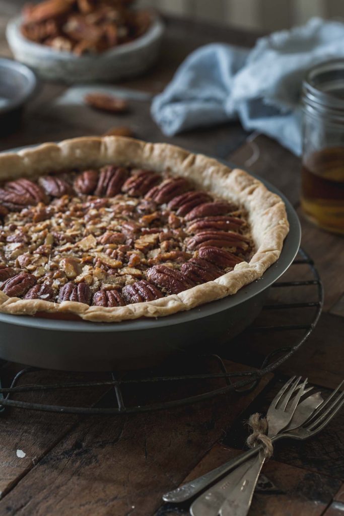 Close up image of full Vegan Salted Bourbon Pecan Pie in pie pan