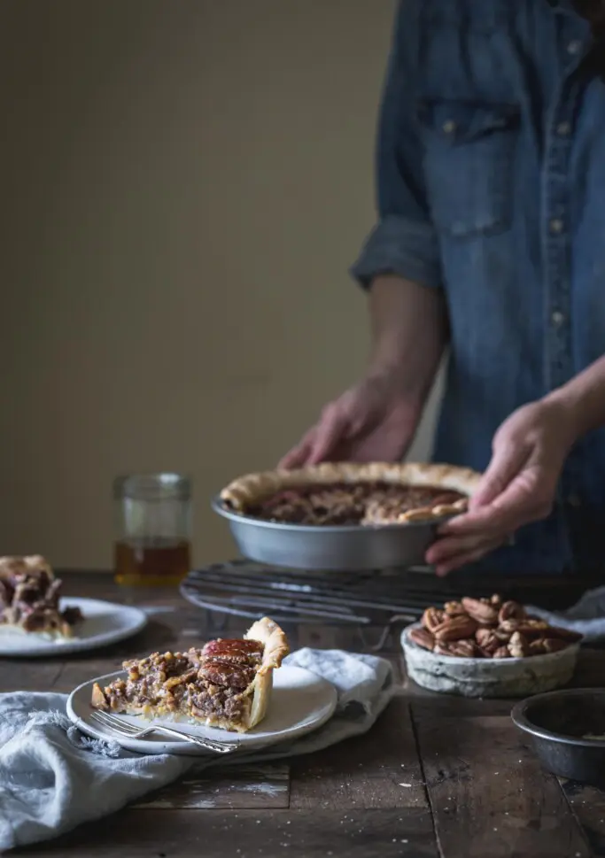 Woman serving vegan pecan pie