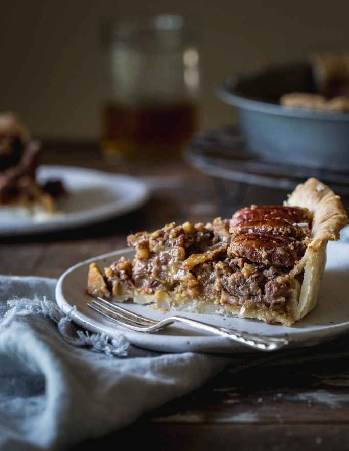 Close-up image of gooey vegan pecan pie slice