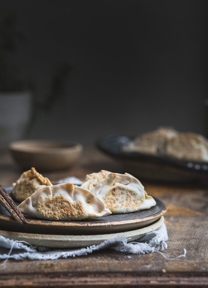 close up image of pan fried mushroom and kimchi dumplings