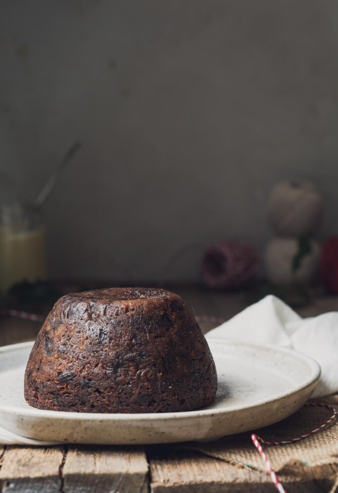 Vegan Christmas Pudding on a rustic table table | shot front on