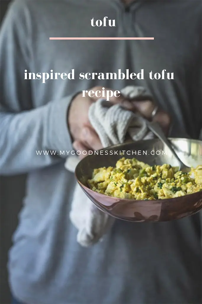 A man holding a skilled of scrambled tofu with text