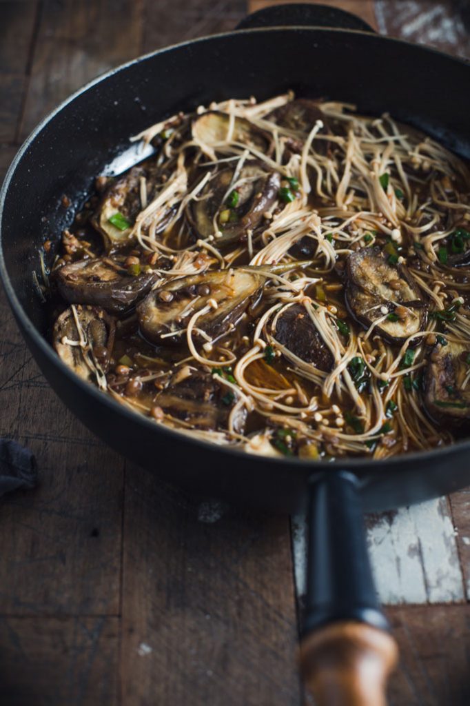 A close up image of the eggplant stir-fry still in its skillet after cooking