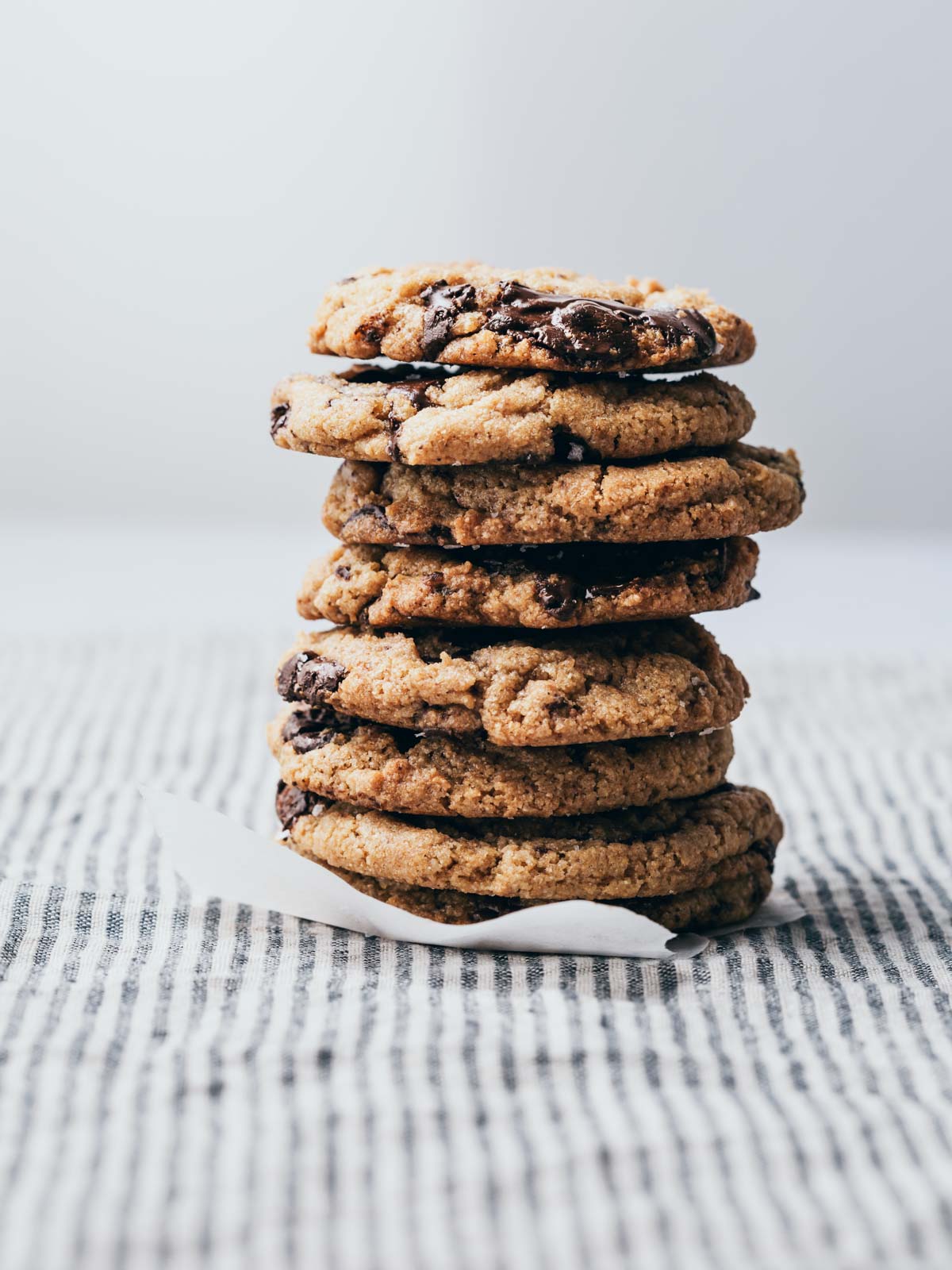 A tall stack of chocolate chip cookies.