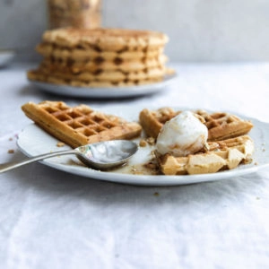 A plate of waffles with a spoon