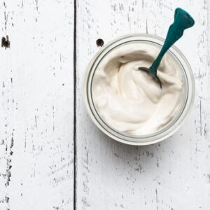 A square image of vegan mayonnaise on a white table