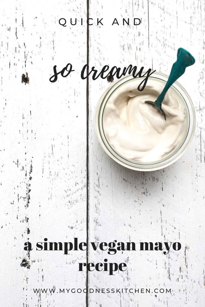 A jar of vegan mayo sitting on a white wooden board with title text overlay