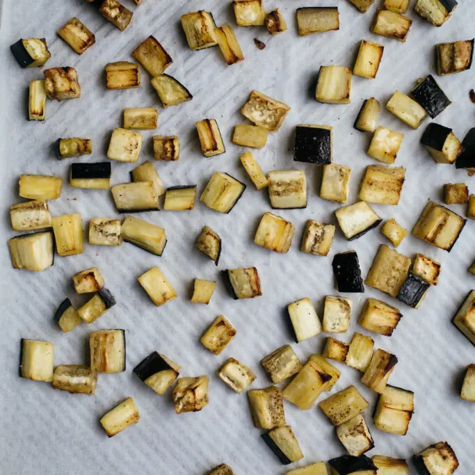 Overhead image of cubed eggplant after roasting in the oven for 30-minutes