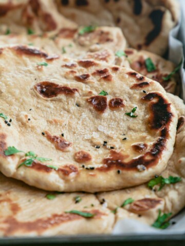 A close up of a stack of naan breads