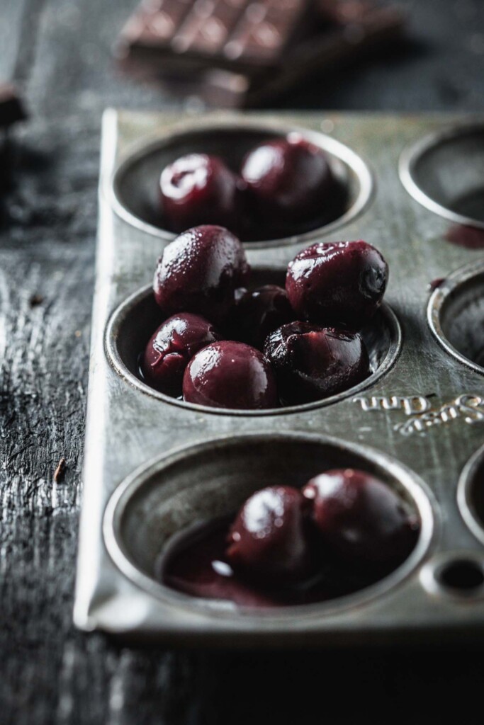 A vintage baking tray with black cherries