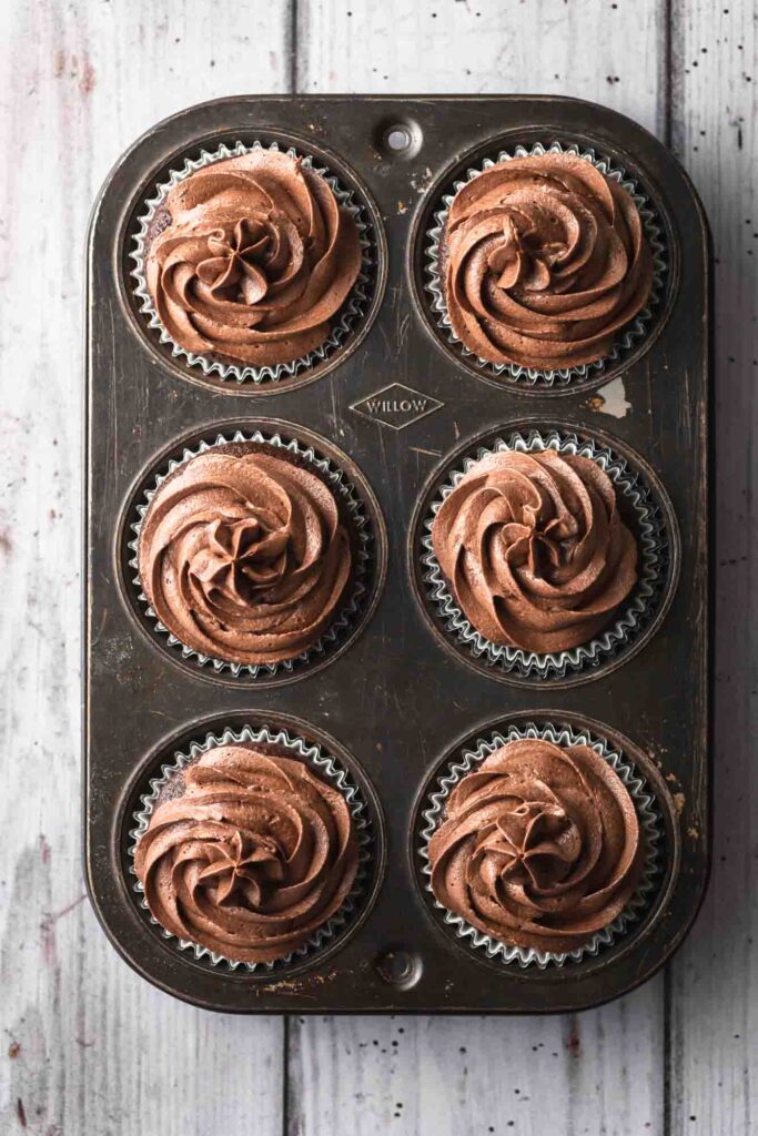 Overhead image of cupcakes with chocolate buttercream swirls