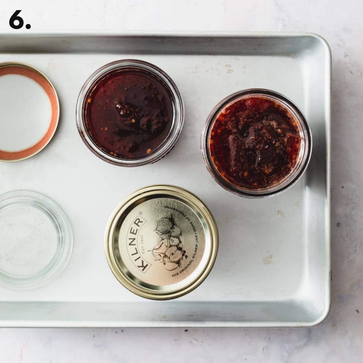 A tray with jars of jam laid out.