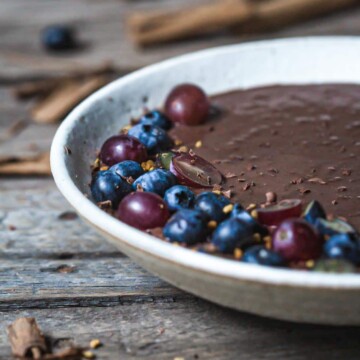 Chocolate chia pudding in a bowl with chopped berries.