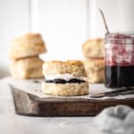 Baked scones on a board with jam.