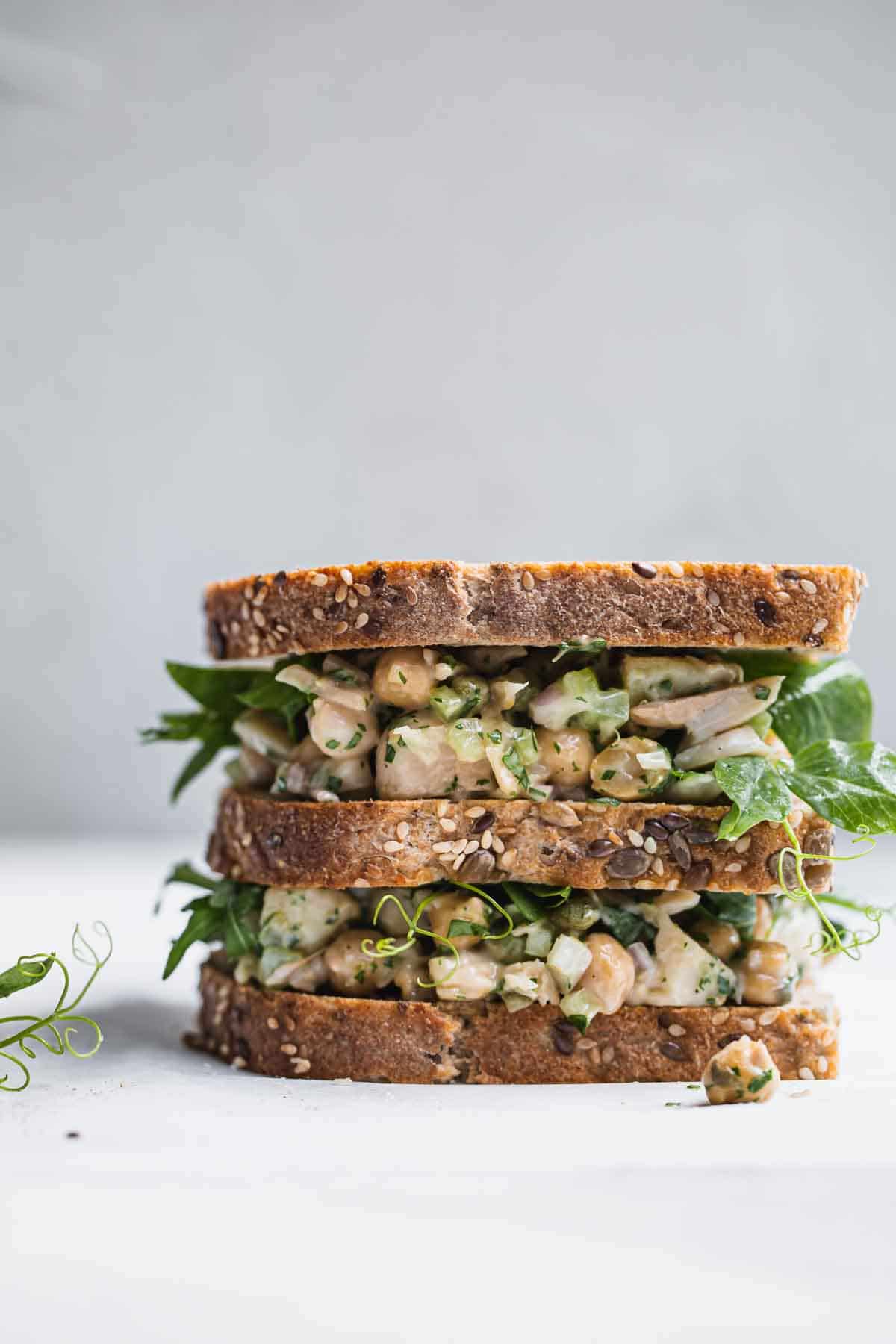 A double sandwich sitting on a white board.
