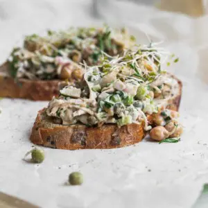 Two slices of bread topped with vegan chicken salad.